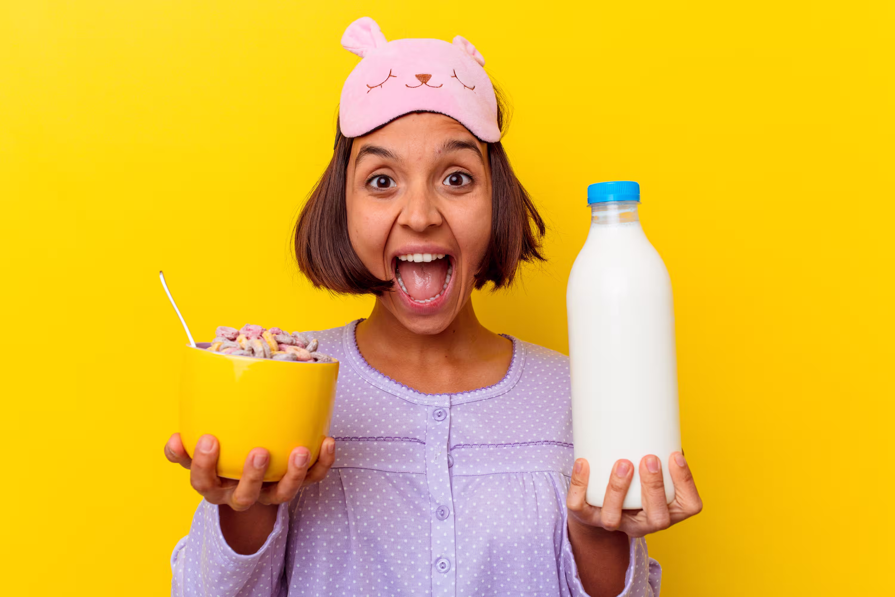 Woman excited holding cereal and milk