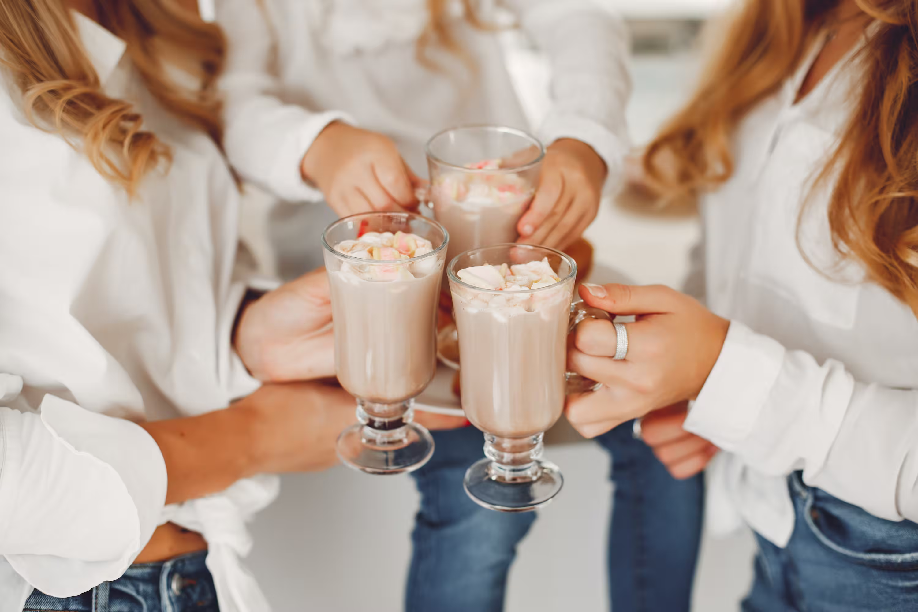 Friends clinking milkshakes